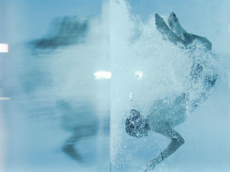 A person in mid-motion during a fluid exercise routine.