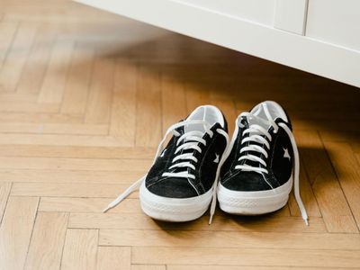 Close-up of comfortable athletic shoes on a wooden floor.